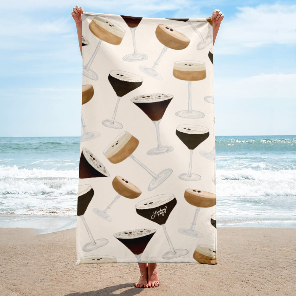 Espresso martini beach towel with hand-illustrated cocktail pattern by Lindsey Kay Collective. Fun and trendy towel for coffee lovers, martini fans, beach days, poolside lounging, and bachelorette gifts. 30x60 cotton polyester towel with cocktail-themed design.